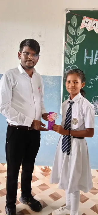 A student presents a gift to her teacher