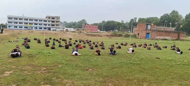 Students in a seated yoga posture on International Yoga Day