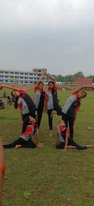 Students hold a group yoga formation